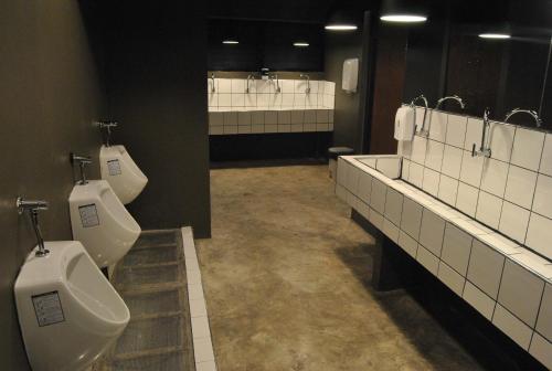 a bathroom with two toilets and two urinals at Capsule Hostel Chiangkhan in Chiang Khan