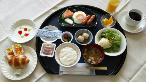 a black plate of food on a table at Narita U-City Hotel in Narita