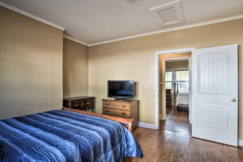 a bedroom with a bed and a flat screen tv at Cozy Greenville Bungalow about 2 Mi to Downtown! in Greenville