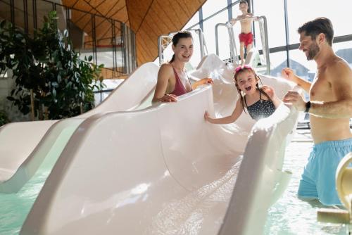 a group of people on a water slide at a resort at Terme Olimia - Aparthotel Rosa in Podčetrtek