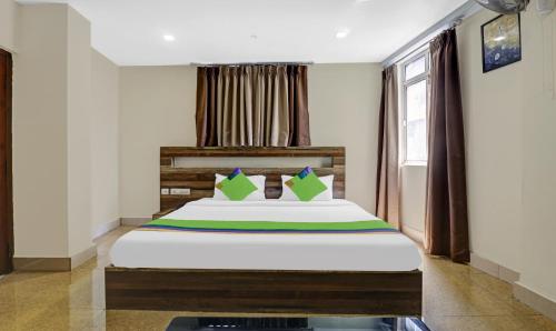 a bedroom with a bed and a window at Treebo Darwesh Residency - 500m from Railway Station in Kozhikode