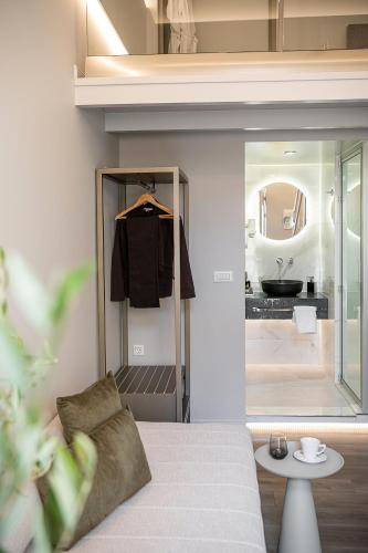a room with a bed and a bathroom with a sink at Elia Erato in Chania
