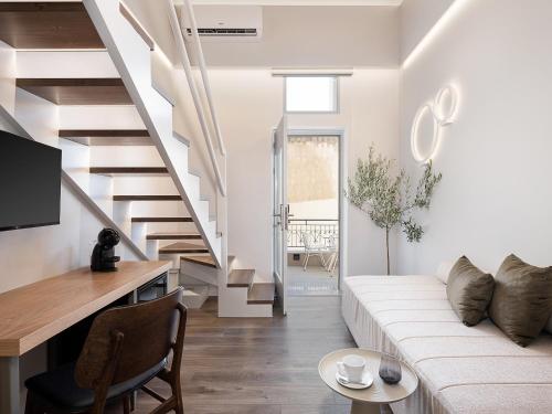 ein Wohnzimmer mit einer weißen Couch und einer Treppe in der Unterkunft Elia Erato in Chania