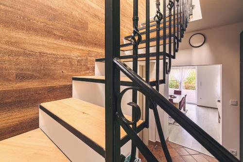 a staircase in a house with a wooden wall at Mártoni Villa in Szigetszentmárton