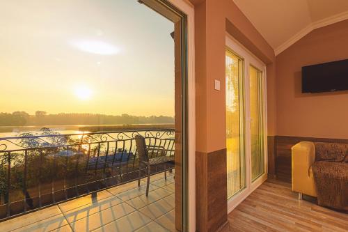 a room with a balcony with a view at Mártoni Villa in Szigetszentmárton