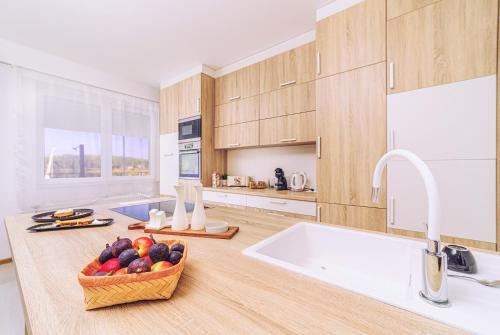 a kitchen with a bowl of fruit on a counter at Mártoni Villa in Szigetszentmárton