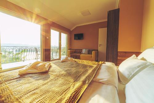 a bedroom with two beds and a large window at Mártoni Villa in Szigetszentmárton