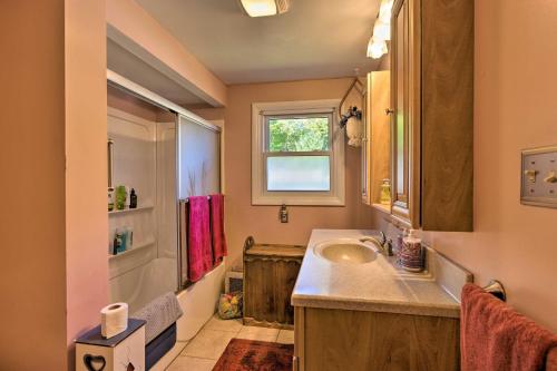 a bathroom with a sink and a shower at Lakefront Ludington Retreat with Kayaks and Fire Pit! in Ludington