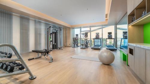 a gym with several treadmills and exercise machines at Holiday Inn Changsha Malanshan by IHG in Changsha