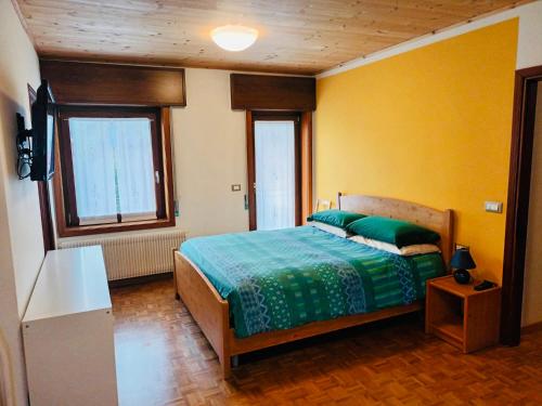 En eller flere senger på et rom på Delizioso appartamento a Canove di Roana