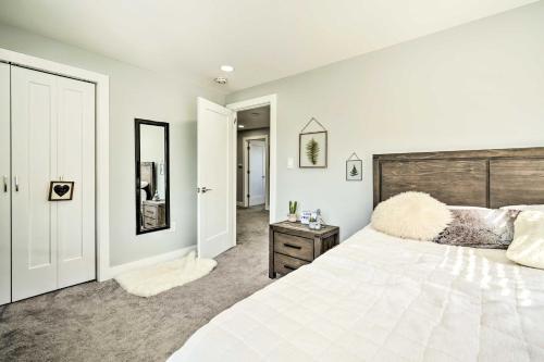 a bedroom with a large white bed and a mirror at Long Branch Getaway Grill, 1 Block to Beach! in Long Branch