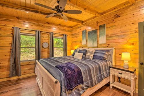 a bedroom with a bed in a log cabin at Clayton Retreat with Spacious Deck and Mtn Views! in Clayton