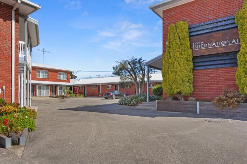 a building with a sign on the side of it at The International Motel Apollo Bay in Apollo Bay