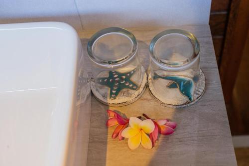 a pair of shoes and flowers on a table at Pondooks Joglo in Nusa Lembongan