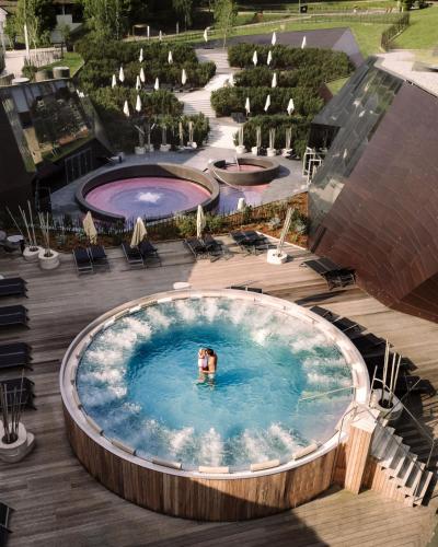 a person swimming in a large pool in a pool at Terme Olimia - Hotel Breza in Podčetrtek