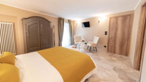 a bedroom with a bed and a table and chairs at Ca' Ginet in Cravanzana