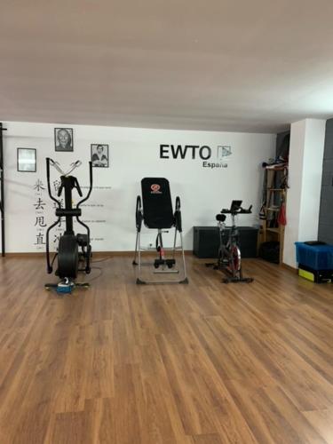a gym with several exercise equipment in a room at AIR FERVENZA in Dumbría