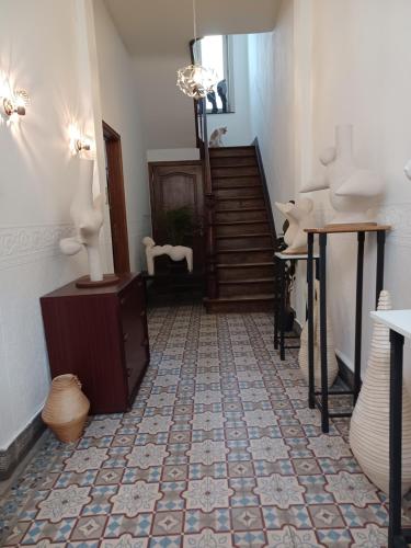 a room with a staircase and a tile floor at De Galerie - green leaves in Ieper