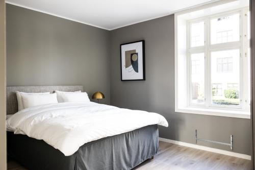 a bedroom with a large bed and a window at Frogner House - Uranienborg in Oslo