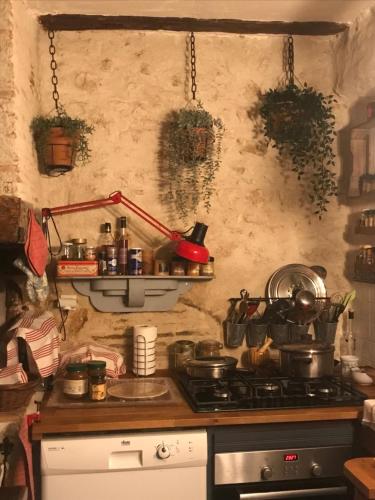 a kitchen with a stove and some pots and pans at Chambre d'Hôtes chez Gustave & Compagnie in Choussy
