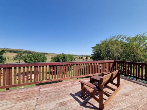a wooden bench sitting on a wooden deck at Kwetu Guest Farm in Swellendam