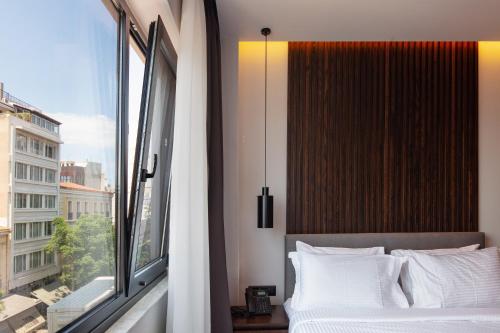 a bedroom with a bed and a large window at Athens Tower in Athens