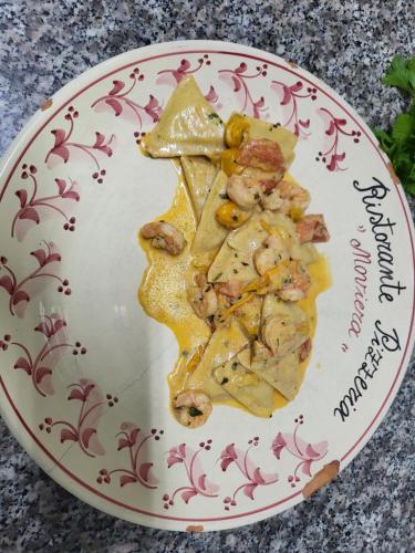 a plate with a slice of pizza on it at Hotel Salento in Specchia