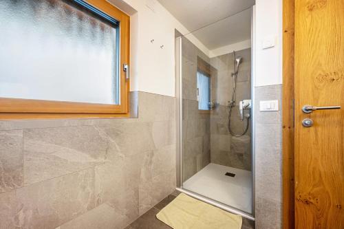 a bathroom with a shower with a glass door at App Kronplatz Villa Colli in Valdaora