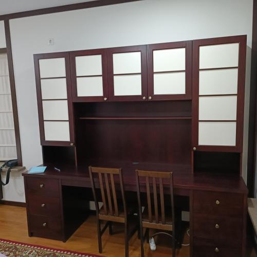 a wooden desk with two chairs and a table at Happy Flower Guesthouse in Verkhnyaya Alaarcha