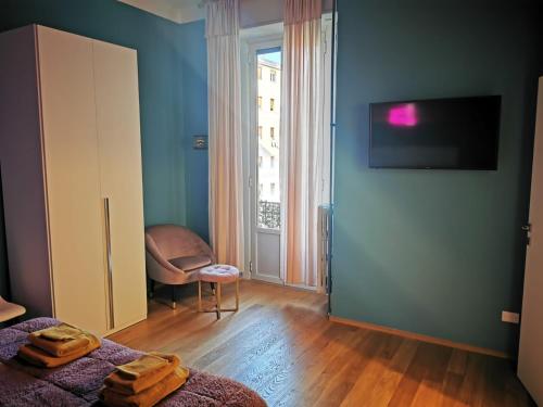 a room with two beds and a tv on a wall at Amio Apartment - next to M5 Ca Granda in Milan