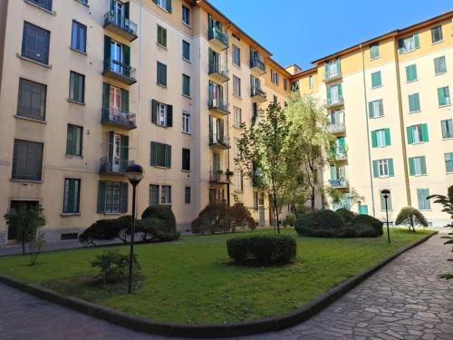 a park in front of some apartment buildings at Amio Apartment - next to M5 Ca Granda in Milan