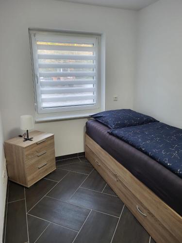a bedroom with a bed and a window at Gästewohnung 2 in Oschersleben