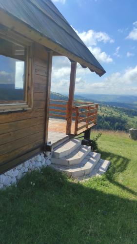 a small building with stairs next to a window at Zlatarski raj in Muškovina