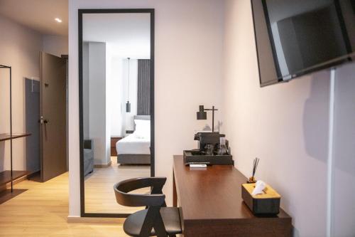 a room with a mirror and a desk with a chair at Athens Tower in Athens