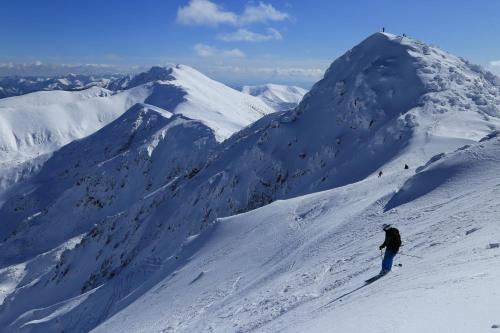 a person skiing down a snow covered mountain at Ski & Wellness Residence Družba in Demanovska Dolina