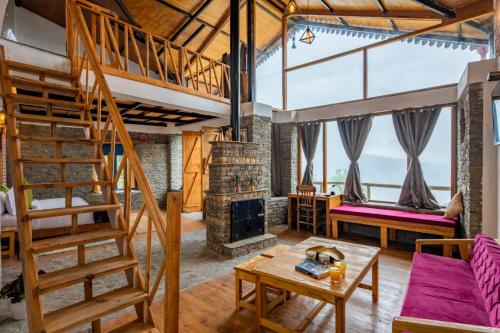 a room with a loft with a fireplace at THE CEDAR CASTLE in Mukteswar