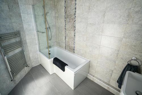 a bathroom with a bath tub and a shower at Longsands Lodge in Tynemouth