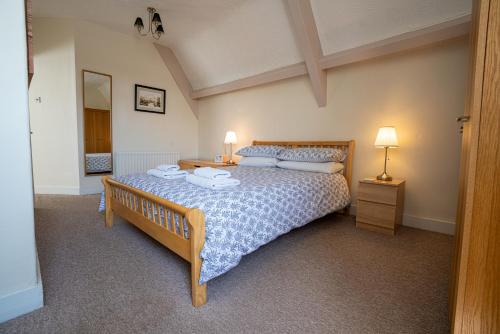 a bedroom with a bed with two towels on it at Longsands Lodge in Tynemouth