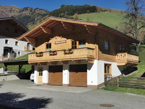 a large wooden building with a balcony on it at Ferienhaus Gschlössl in Rauris