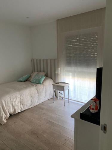a bedroom with a bed and a table and a window at Casa hugo olite in Olite
