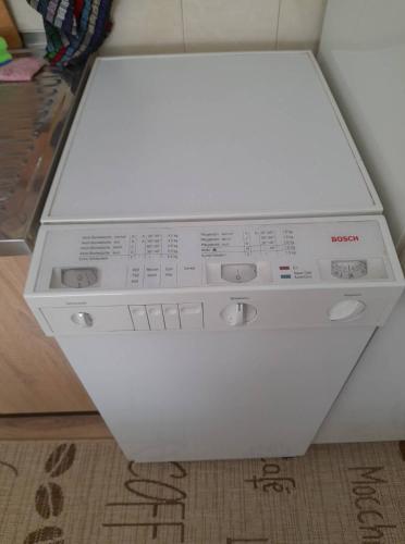 a washing machine is sitting on a rug at Apartment NV in Lutherstadt Eisleben