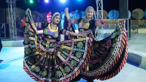 two women in traditional costumes performing at a circus at Marina Dessert Camp in Sām