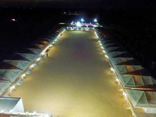 a view of a street at night with lights at Marina Dessert Camp in Sām