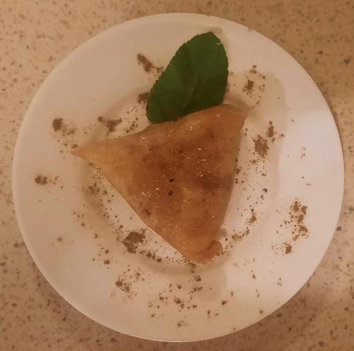 a white plate with a piece of food on it at Maison d'Hôtes Irocha in Tisselday