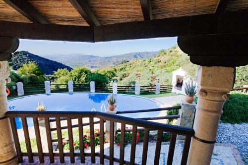a view from the balcony of a house with a swimming pool at Villa El Lagar Rocabella in El Chorro