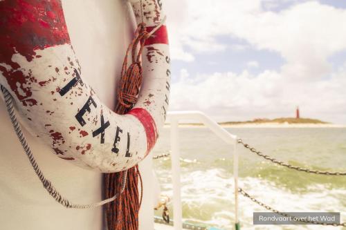 a person on a boat with a persons arm overboard at Hotel Molenbos Texel in De Cocksdorp