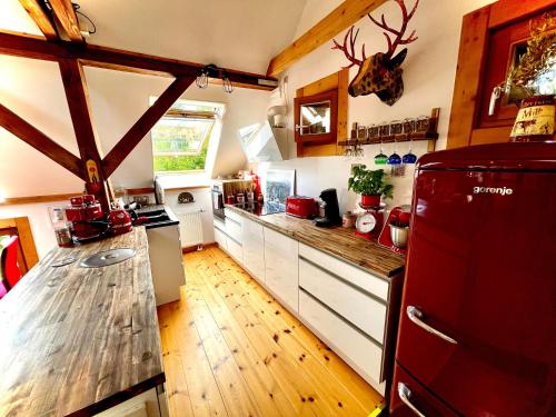 a kitchen with wooden floors and a wooden counter top at Historisches Retro Loft 120m2 + Garten & Seenähe in Schwielowsee