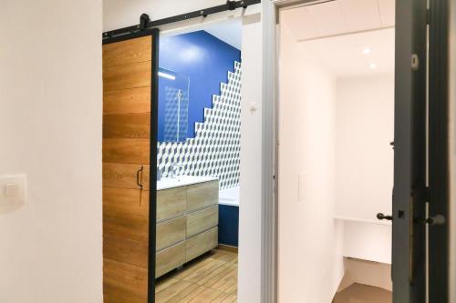 a sliding door in a room with a staircase at Esprit Feydeau- 2 chambres en bail mobilité in Nantes