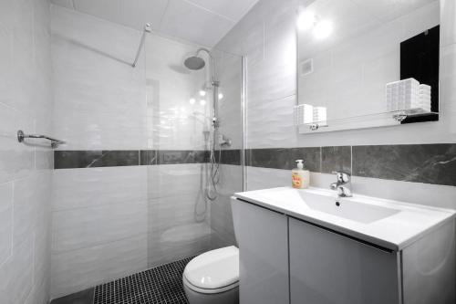 a white bathroom with a sink and a toilet at Bonito apartamento equipado, cerca de la playa in Empuriabrava