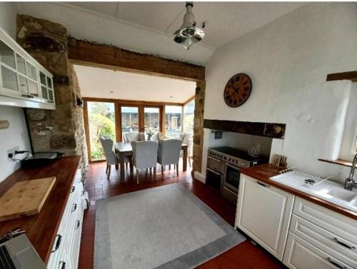 a kitchen with a table and a dining room at Unique Countryside Cottage close to Sunderland in Houghton le Spring